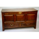 A George II oak mule chest the plain top with moulded lip above a front with three raised fielded