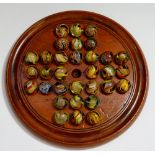 A Victorian walnut solitaire base with a set of 32 contemporary marbles,