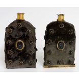 An unusual pair of Persian ? cased white metal  flasks of arched form with applied surface and