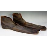 An interesting pair of late 19th / early 20th Century clowns'  shoes with leather uppers and wooden