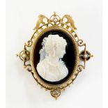 A Victorian shell cameo the gold frame enclosing an oval finely carved with a head and shoulder