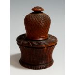 A mid-19th Century engine turned wooden nutmeg grater, the waisted base with turned borders,