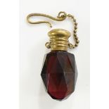 A Victorian brass mounted ruby glass scent bottle of faceted oval form, bun shaped cover,