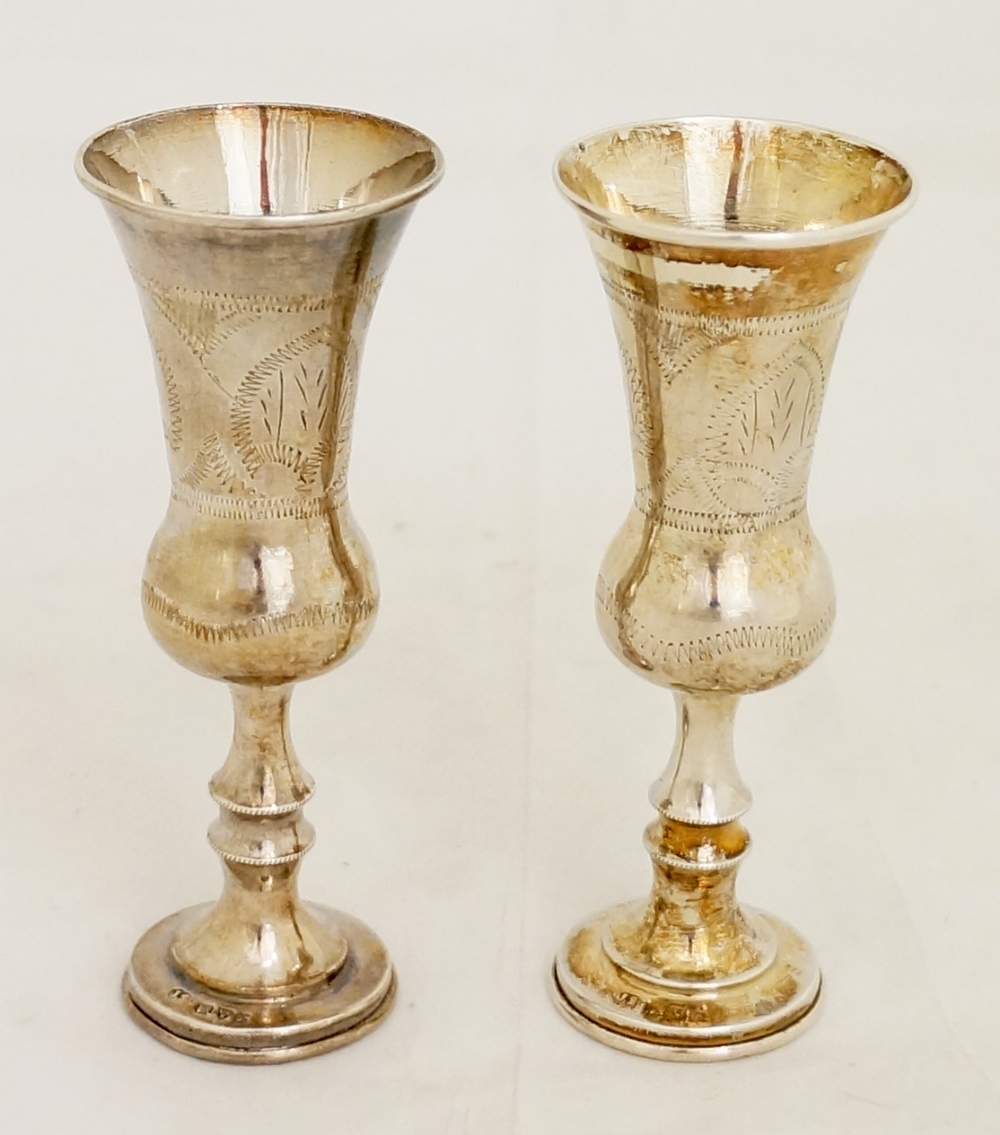 A pair of  Edward VII Kiddush Goblets, thistle shaped on circular feet, wriggle work engraved.,