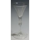 An 18th Century Kit Kat form wineglass, drawn trumpet bowl over teared knop stem on conical foot,