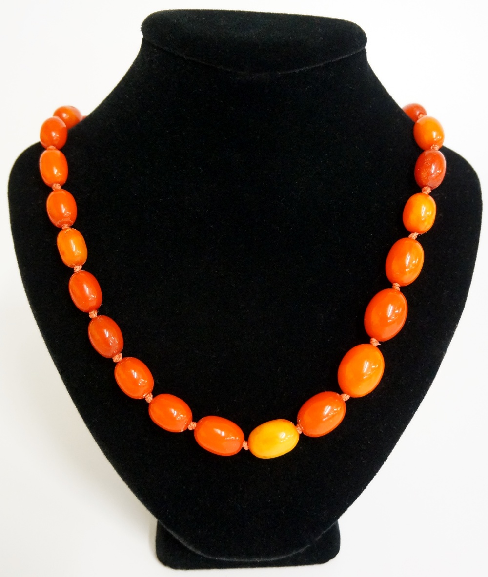 A single string of graduated amber beads, 90cm long, - Image 2 of 2