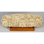 A Cantonese carved ivory panel of shaped rectangular outline,