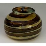 A compressed globular tortoiseshell coloured glass vase, signed to base Michael Harris,