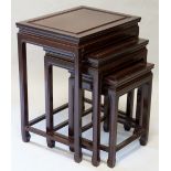 A nest of three Chinese hardwood tables the rectangular tops panelled with plain legs joined by