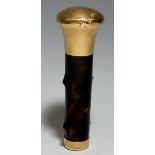A George V 9ct gold and tortoiseshell cane handle with bun shaped cover and slightly tapered