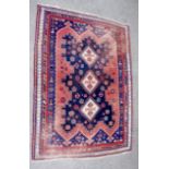 A Persian Afshar rug worked with three cream geometric medallions on a blue ground within a larger