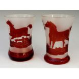 Two similar Bohemian ruby flashed waisted beakers each decorated with horses and dogs,