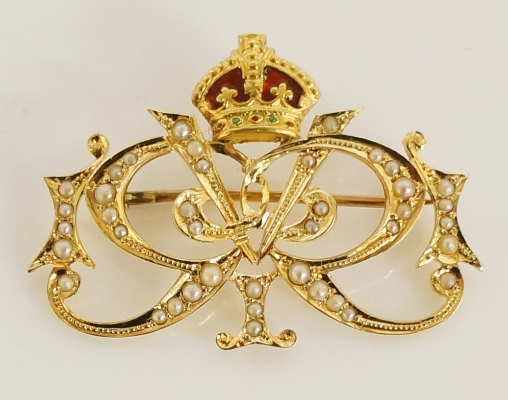 A 15 carat gold seed pearl set Cipher brooch with red enamelled crown the brooch seed pearl set as