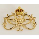A 15 carat gold seed pearl set Cipher brooch with red enamelled crown the brooch seed pearl set as