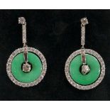 A pair of jadeite and diamond earrings the circular jadeite discs pierced at the centre surrounded