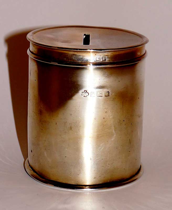 A George V silver money box of cylindrical design the pull off lid with coin aperture, 8 cm high,