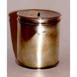 A George V silver money box of cylindrical design the pull off lid with coin aperture, 8 cm high,