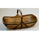 A wooden trug of conventional design with bent wood handle,
