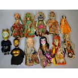 A small collection of painted wooden headed puppets the masks including various mythical and other