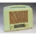 An Ekco Model U122 green bakelite radio, 24cm high, 29cm wide; together with the original guarantee,