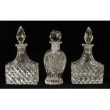 A pair of cut glass cologne bottles with diamond pattern to body, tear shaped stoppers, 12cm high,