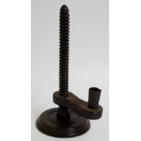 An 18th Century ebonised fruitwood rise and fall candlestick with threaded column,