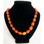 A single string of graduated amber beads, 90cm long,