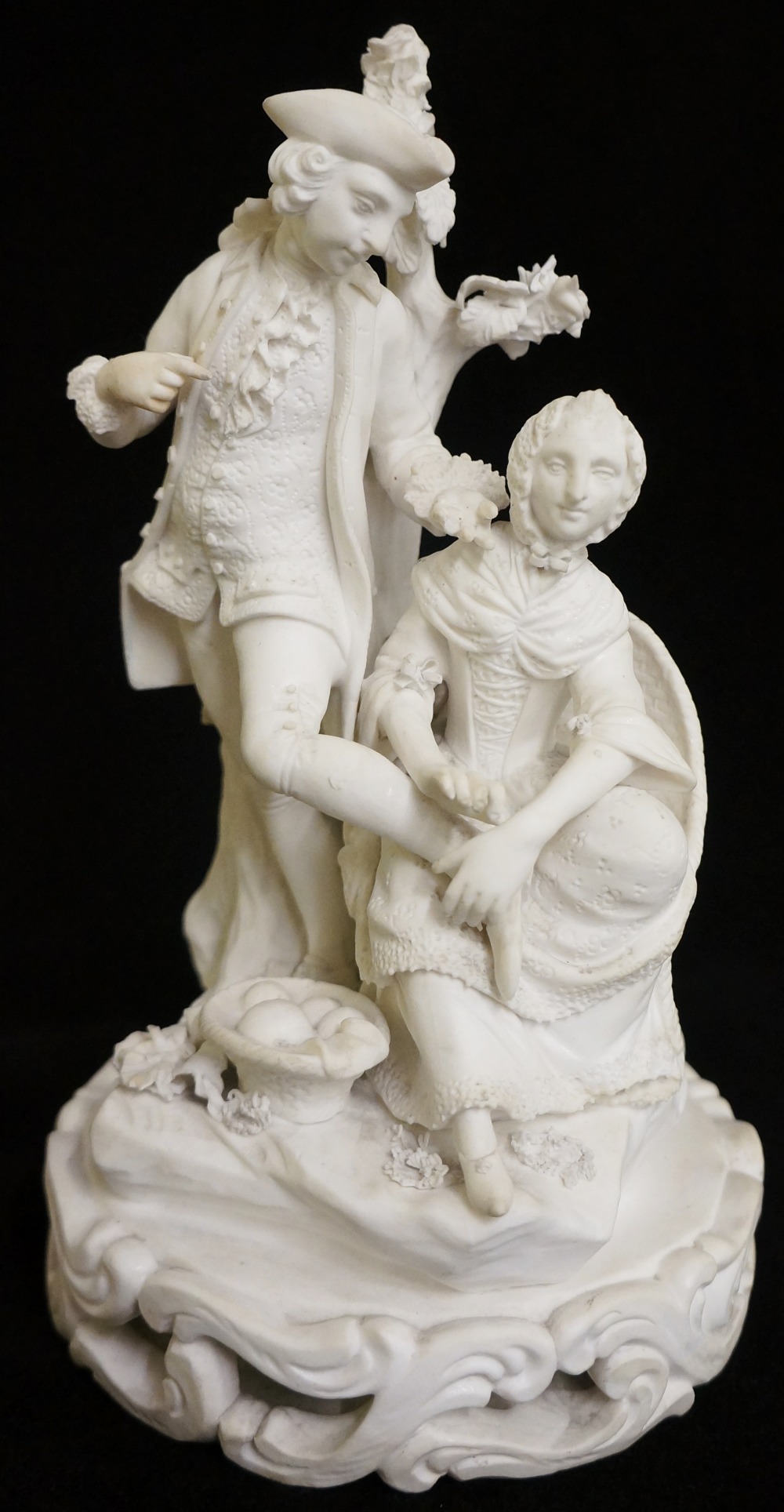 A Derby biscuit porcelain figure of a gallant and his companion in 18th Century attire,