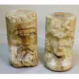 A pair of medieval stone pillar fragments carved with a male bearded mask and female mask,