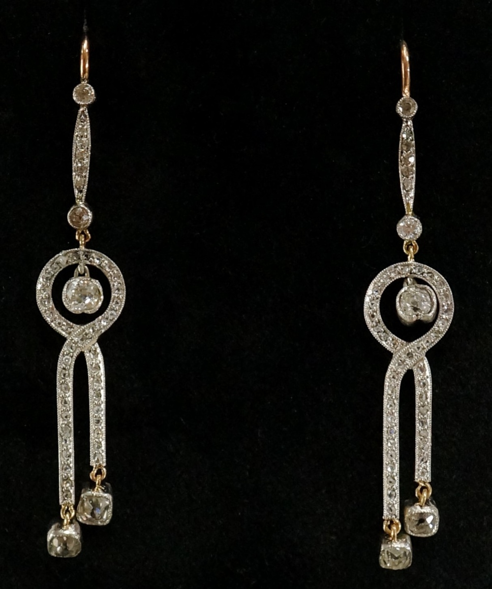 A pair of diamond earrings of interlaced design each set three suspended brilliants on a narrow - Image 2 of 2