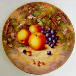 A Royal Worcester circular plate still life painted with apples, grapes,