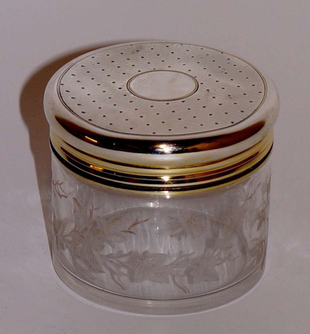 Asprey & Co - a silver dressing table jar of cylindrical design the glass body wheel engraved with