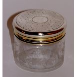 Asprey & Co - a silver dressing table jar of cylindrical design the glass body wheel engraved with