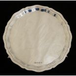 A modern plain salver, with pie crust rim on scroll feet, E.Viner, Sheffield, 1954, 19.