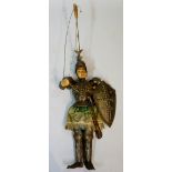 A theatrical puppet with carved wood head and hands,