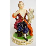 An early 19th Century Derby figure of a seated woman with dog on her knee,