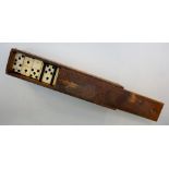 A set of bone faced ebony dominoes, contained in a wooden box with sliding lid, box 27.