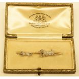 A white gold and diamond bar brooch modelled as a Terrier chasing a rat,