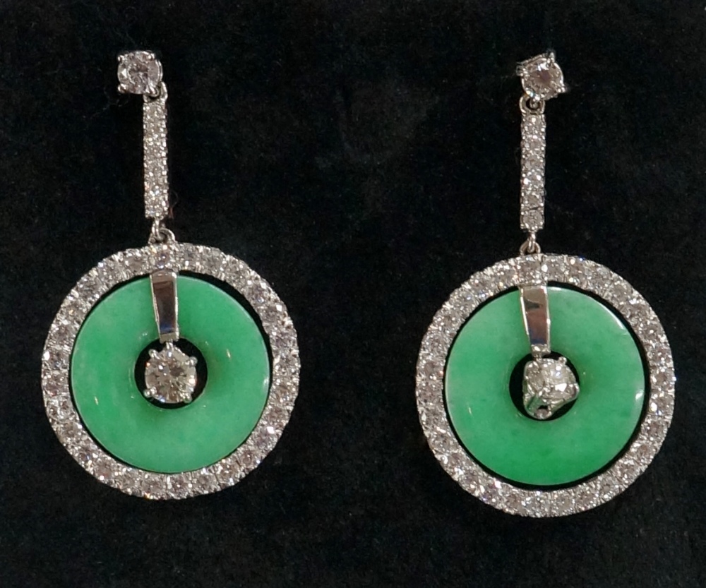 A pair of jadeite and diamond earrings the circular jadeite discs pierced at the centre surrounded - Image 2 of 2