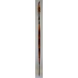 A double ended tribal spear, the wooden shaft carved with iron tips,