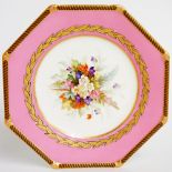 A Worcester octagonal plate painted to the centre with a floral spray within jeweled gilt and black