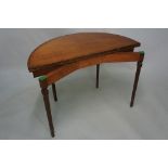 A George III mahogany half round tea table cross banded and ebony and boxwood inlaid throughout on