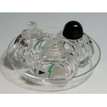 An Art Deco glass three piece cruet set on circular tray,