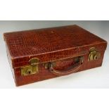 A Ladies crocodile case with silk lined interior, brass locks inscribed British Made, 40cm wide,