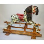 A Haddon Rocker's rocking horse the dapple grey body with red tooled leather saddle with padded