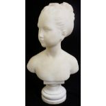 A white marble head and shoulder bust of a young girl, her hair ribbon tied, on a circular socle,