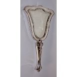 An Edward VII silver hand mirror in Art Nouveau style embossed with flower heads and trailing