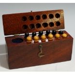 A mahogany box containing six boxwood and six ebony pegs,