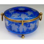 A circular blue glass box, the lid and sides finely etched with trailing vines and grapes,