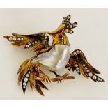 A Victorian baroque pearl brooch modelled as a stylised bird the  gold? head with seed pearl and